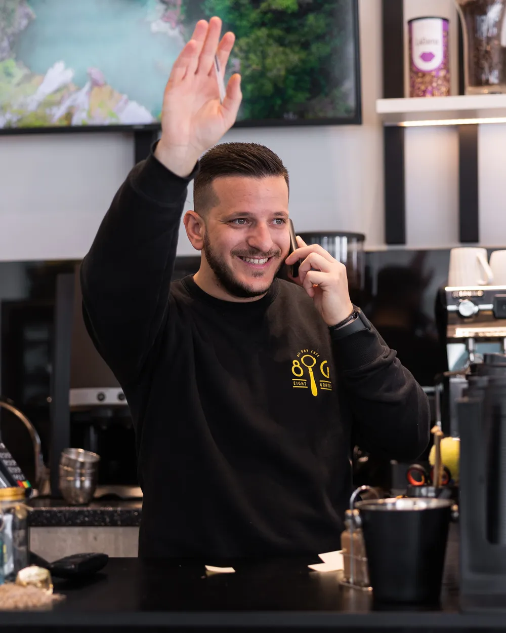 Vasilis Xrysanthopoulos waves from behind the counter at Eight Grams.